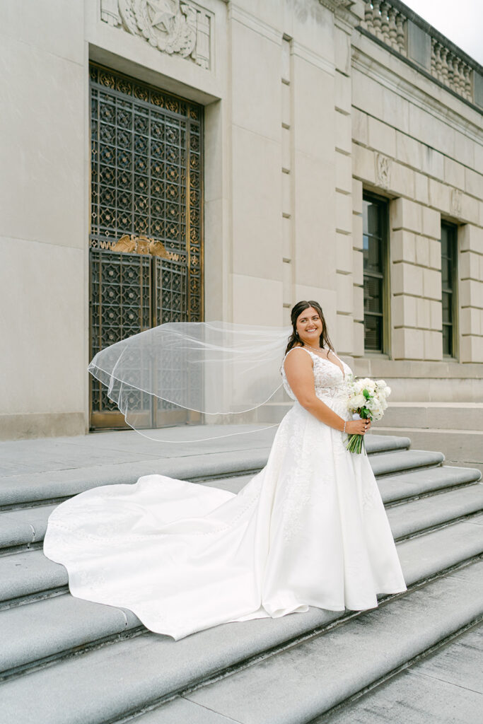Beautiful bride posing with wedding veil.