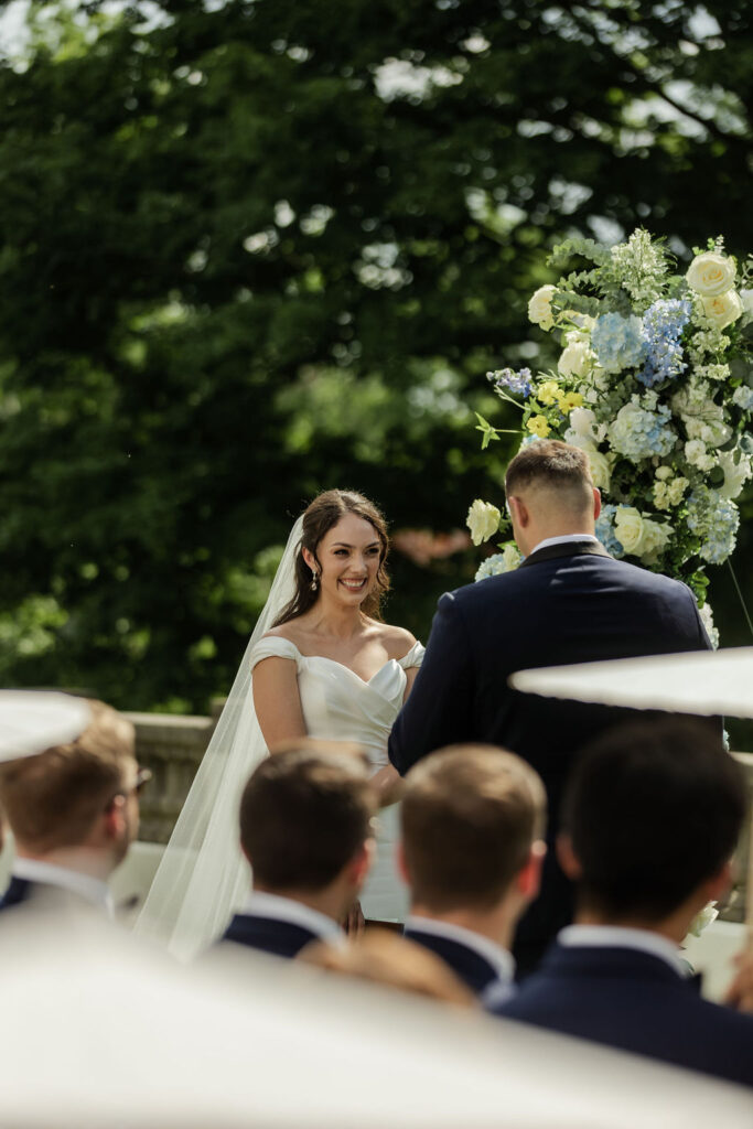 groom reading vows to his bride during the ceremony at newfields, brides reaction