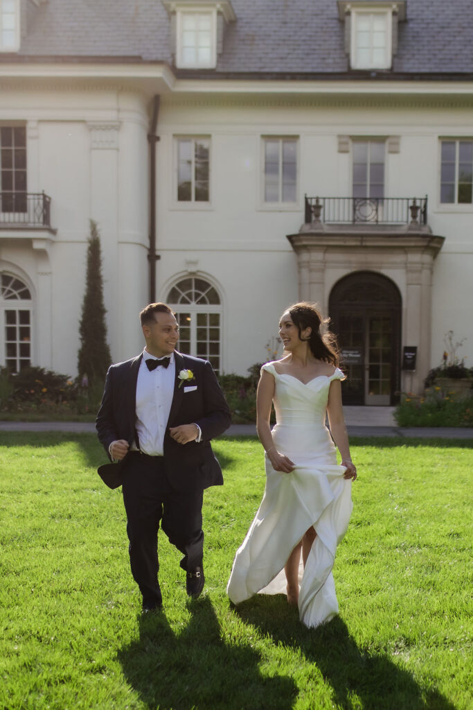 newly weds running together in front of the lilly house newfields indianapolis