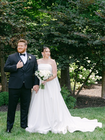 Couple posing near their wedding venue at Barn at Bay Horse Inn.