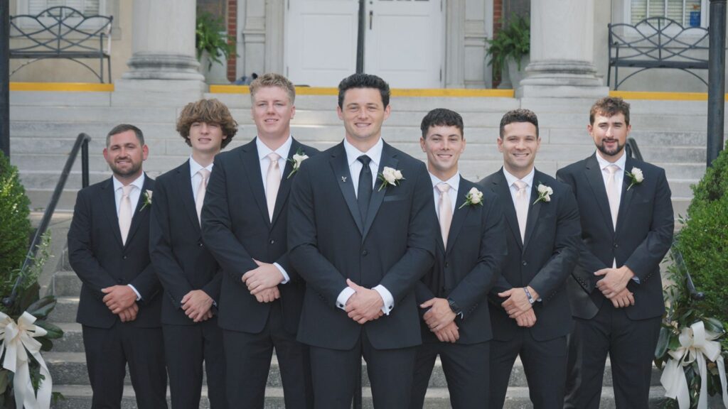 Groom and groomsmen posing in front of The Olmsted Wedding Venue.