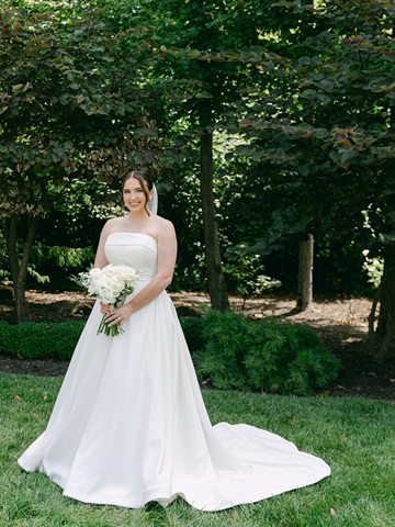 Bride posing at Barn at Bay Horse Inn wedding venue after being proposed at St. Louis Arch