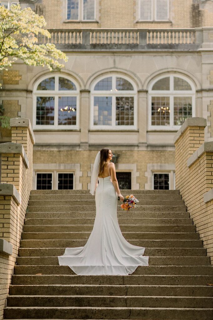Timeless elegance wedding bride standing on stairs of Laurel Hall Indianapolis
