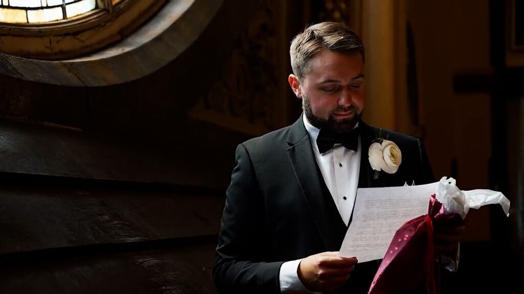 Groom reading letter from bride on his wedding day.