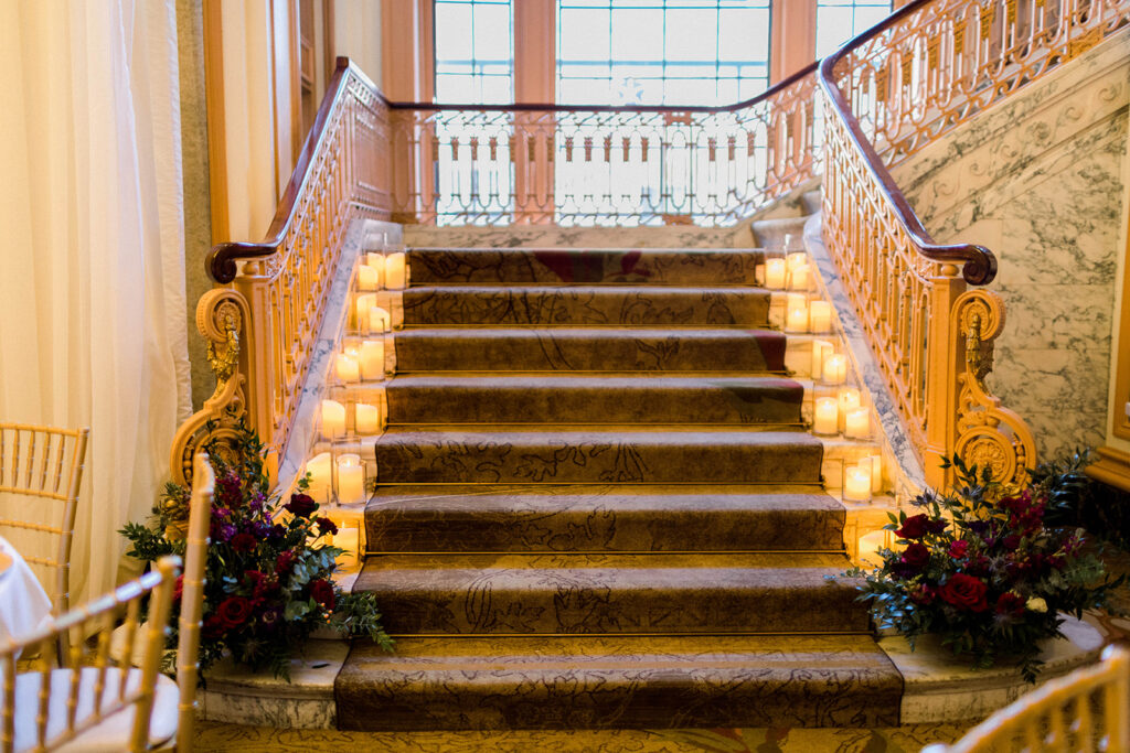 Hotel Omni Severin staircase with candles and florals.