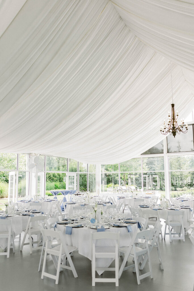 White wedding glass house with beautiful chandeliers.