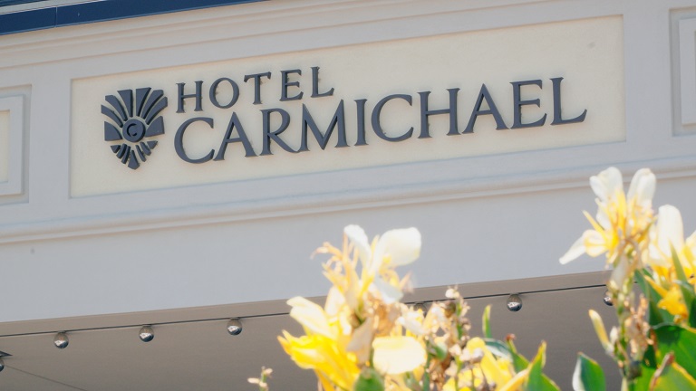 Hotel Carmichael Sign with Florals in foreground.