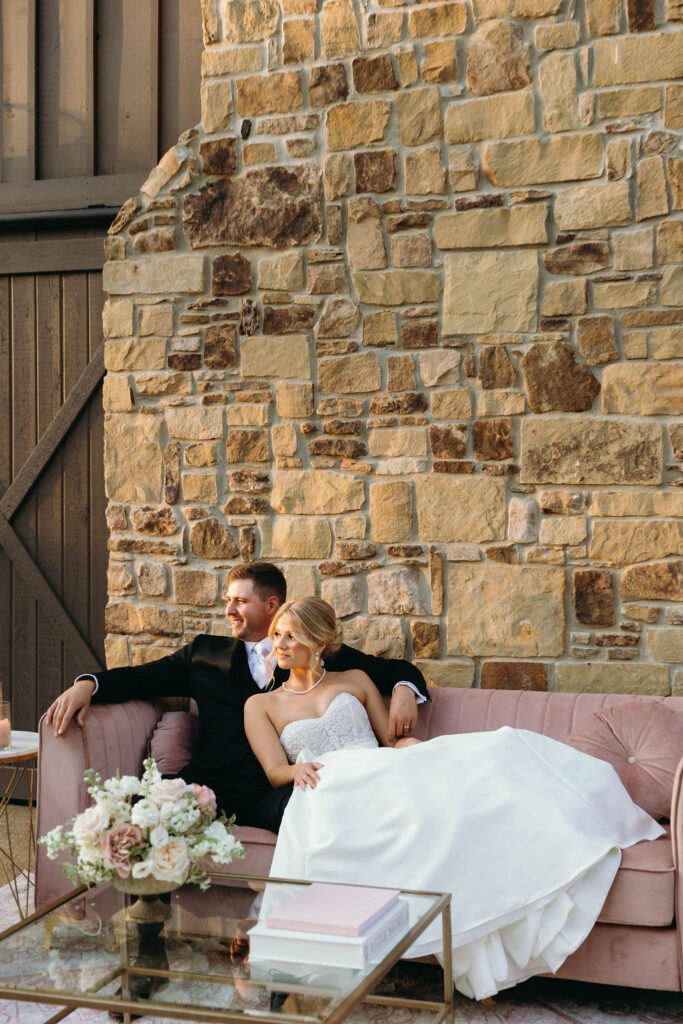 Classic Fall Wedding Couple on couch in front of Barn At Bay Horse Inn